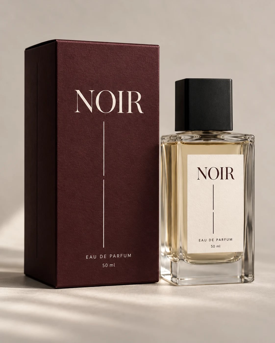 Noir 50 ml perfume bottle beside its burgundy box.